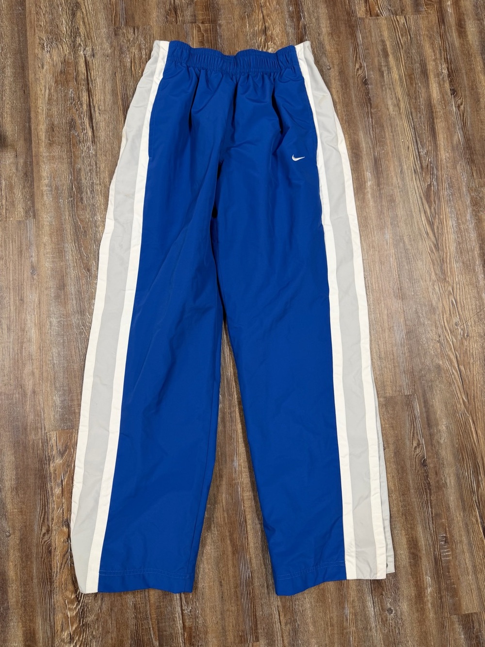 Vintage Nike blue track pants with white side stripes, size S